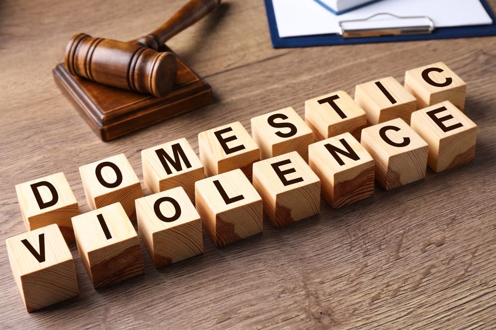 Wooden cubes with words DOMESTIC VIOLENCE on wooden table